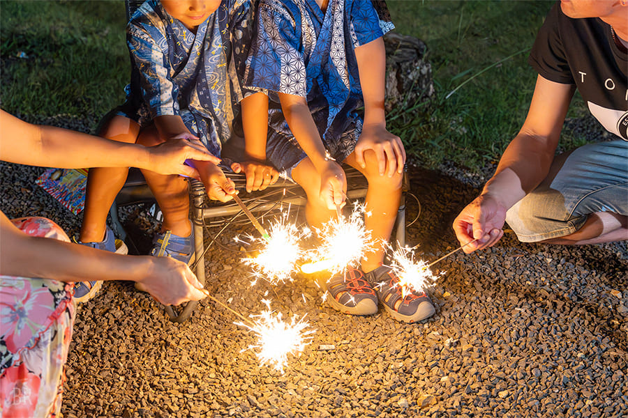 Handheld Fireworks Lighting the Night Sky