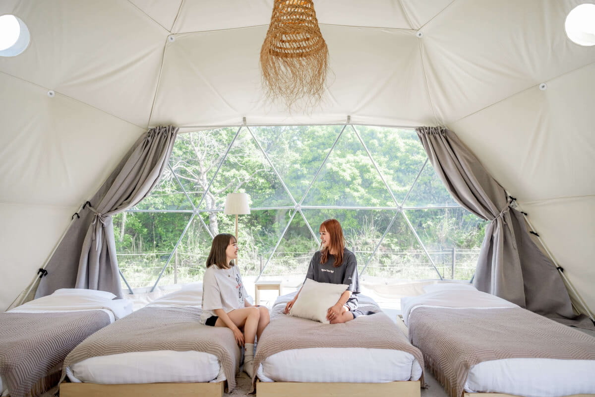 
Photo of a woman relaxing on a bed in a tent