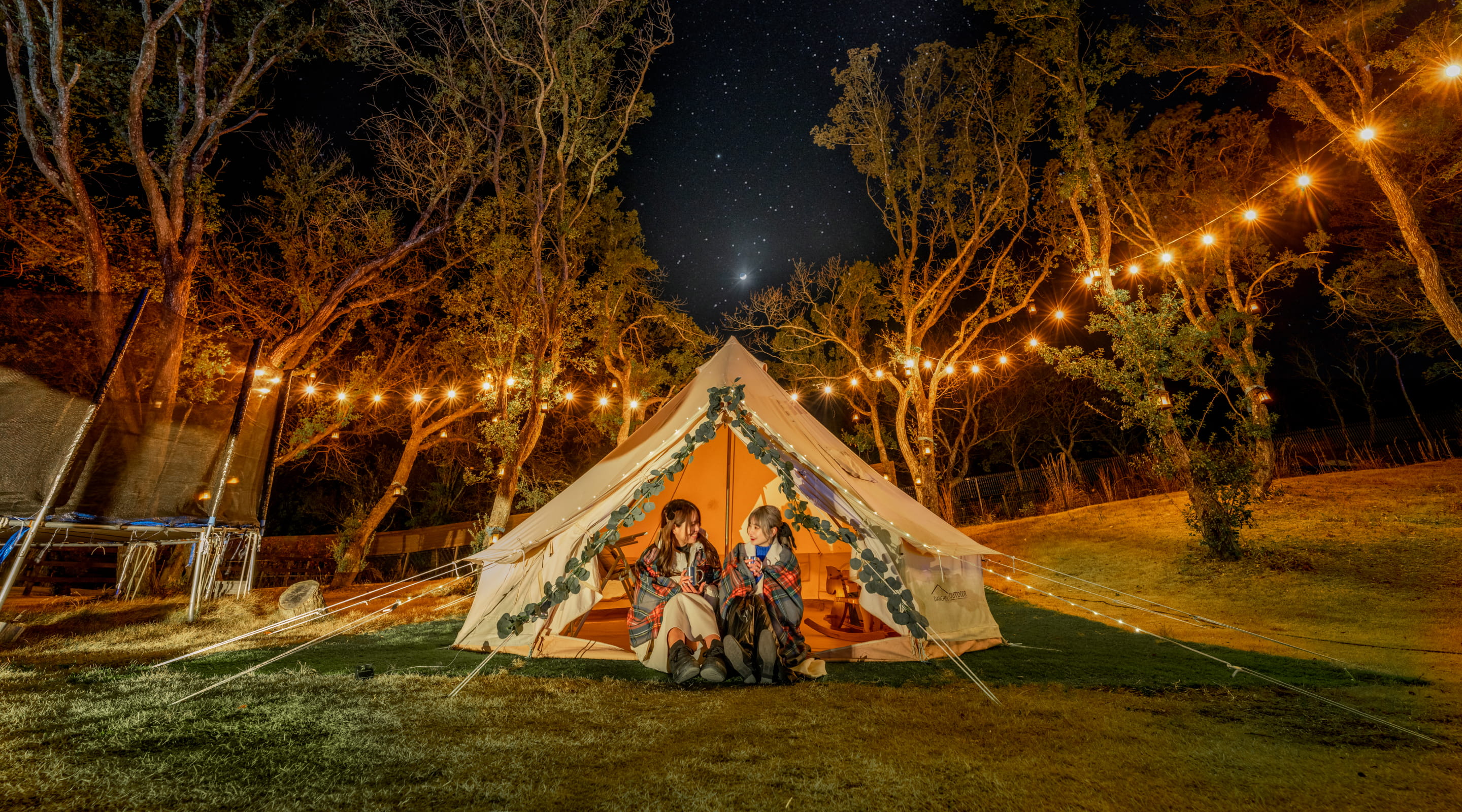 Photo of a woman enjoying illuminations in a tent